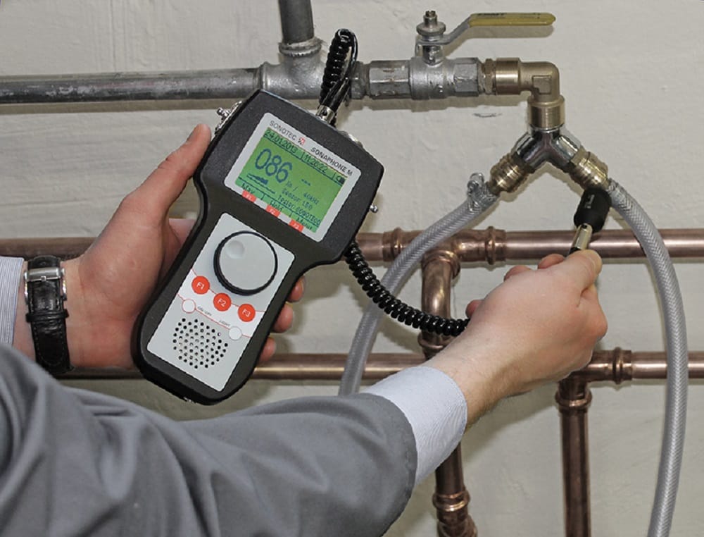 Plumber testing pipes with electronic leak detection equipment in Villa Rica