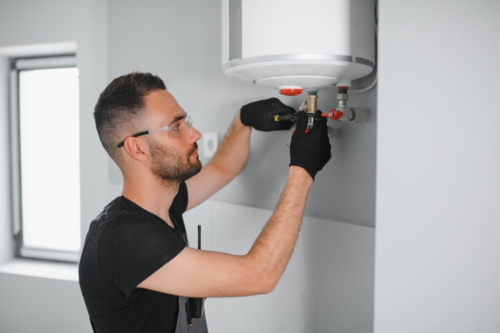 Technician performing water heater maintenance in Villa Rica